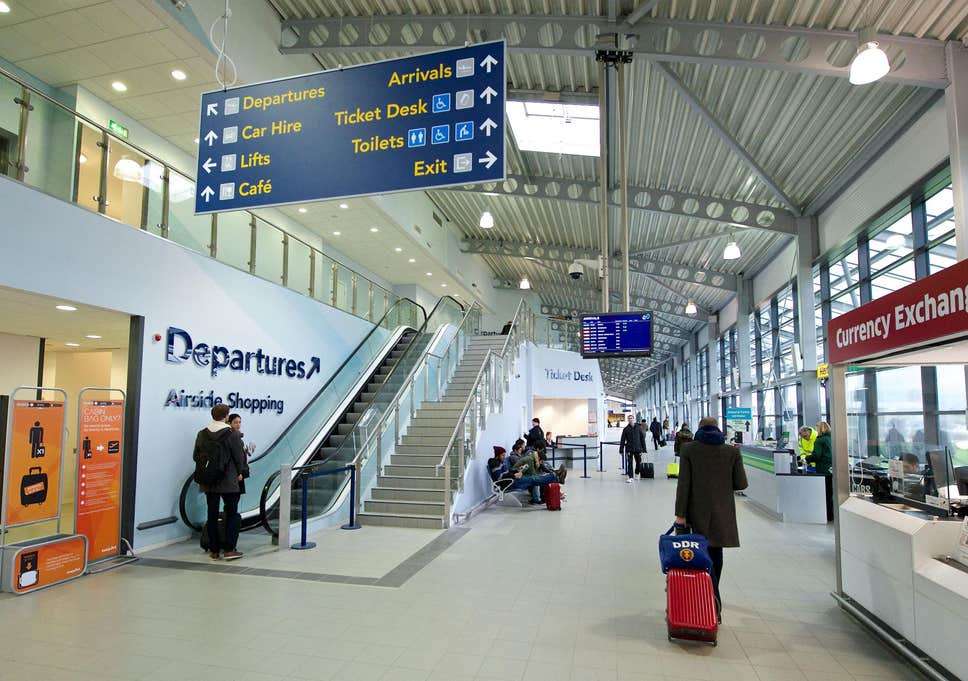 departures-stairs-002 Southend Airport departures area with escalators and signage for ticket desk and car hire.