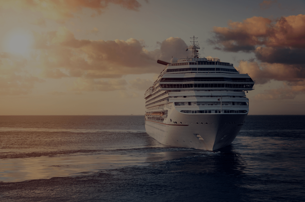 Cruise ship sailing at sunset, UK cruise lines return.