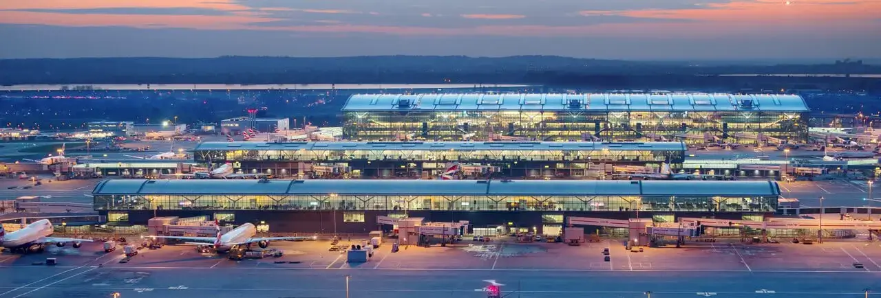 Aerial view of London Heathrow Airport terminal and runways, luxury airport car transfer service.