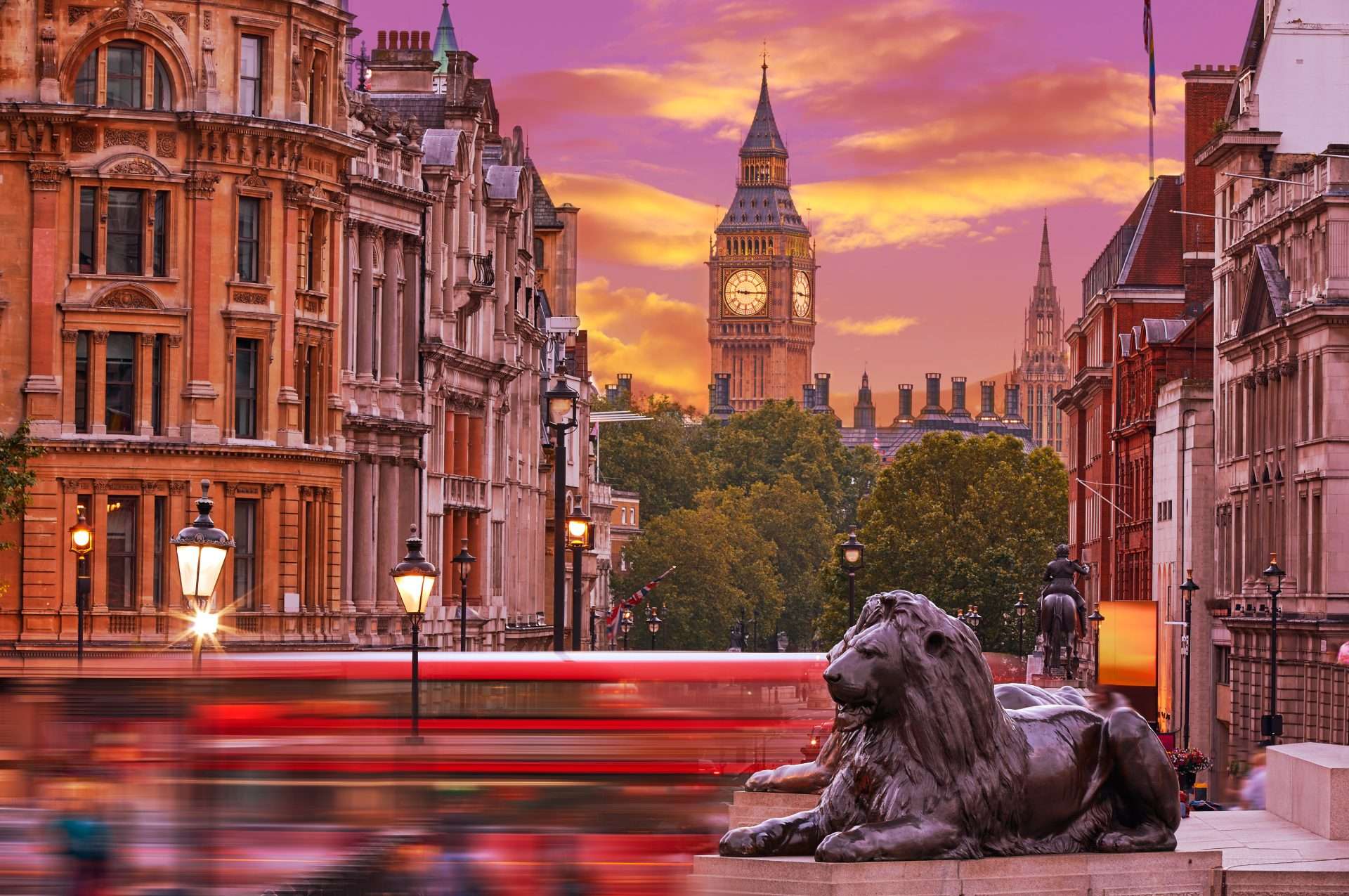 London cityscape with Big Ben and Westminster Palace at sunset, luxury transportation in the foreground.