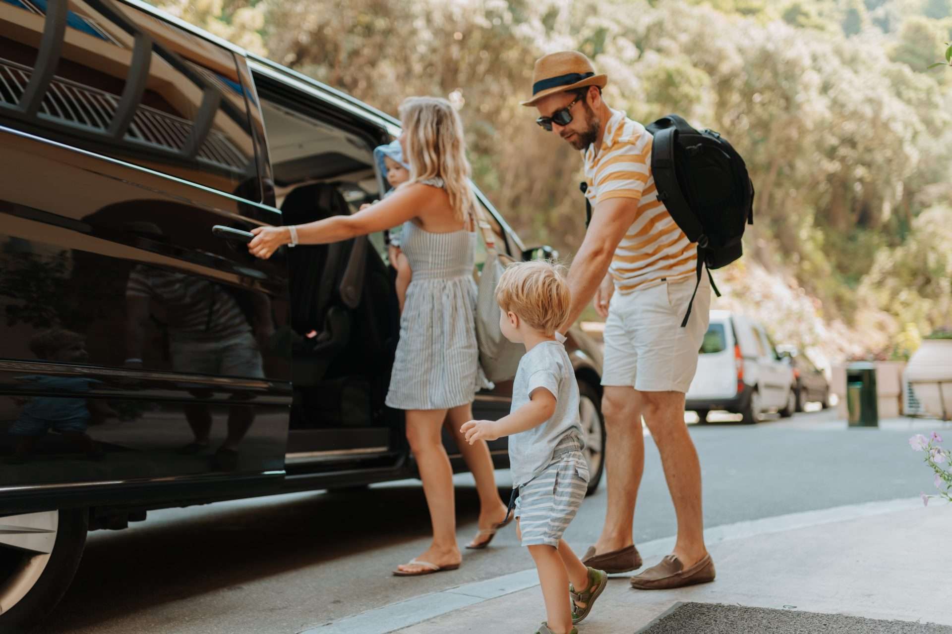 Family arriving at airport for transfer with REAL Transfers vehicle.
